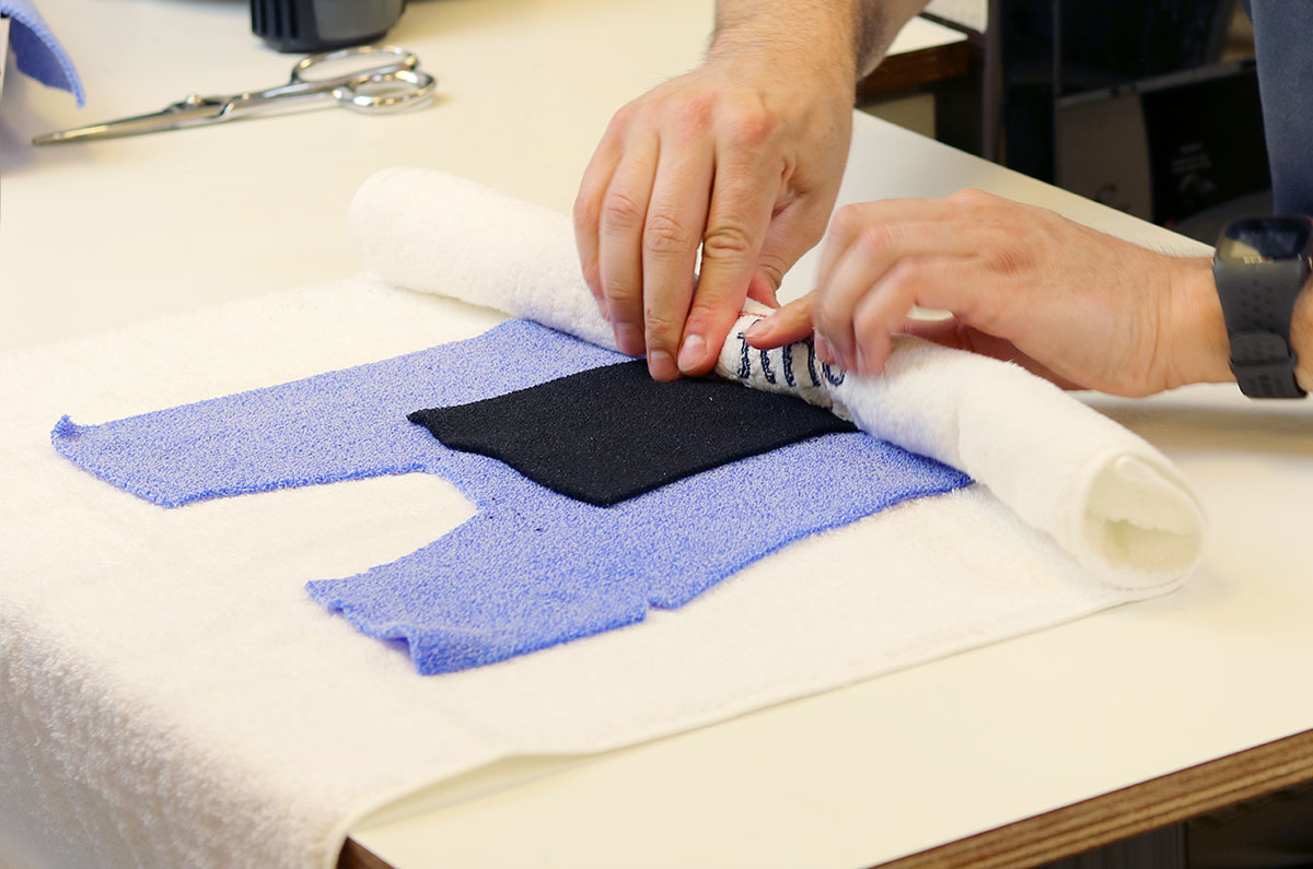 Using a towel to roll excess water out of Muenster orthosis pattern.